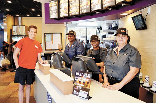 Stephanie Nelson | The Brewton Standard Stewart Campbell, a TRM 10th grader, was among the lunch crowd Monday at Taco Bell. Here, he is being helped by Kim Edgar, regional general manager; Keyondra Mobley, service champion, and Lavita Lett, assistant manager.