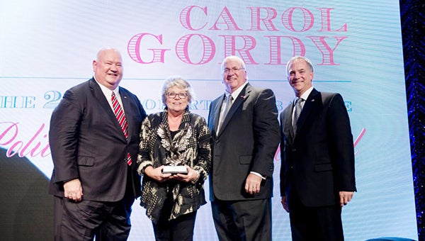 Courtesy photo Brewton business owner Carol Gordy, second from left, receives the 2015 Robert ‘Bubba’ Lee Political Courage Award named for former BCA Chairman Robert “Bubba” Lee, left. Also pictured is BCA’s vice chairman Tommy Lee and BCA Chairman Marty Abroms.