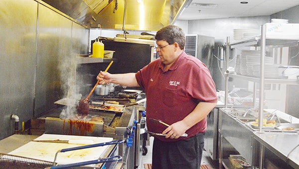Lydia Grimes | The Brewton Standard Adam Manasco dishes it up at Camp 31 BBQ & Grill.