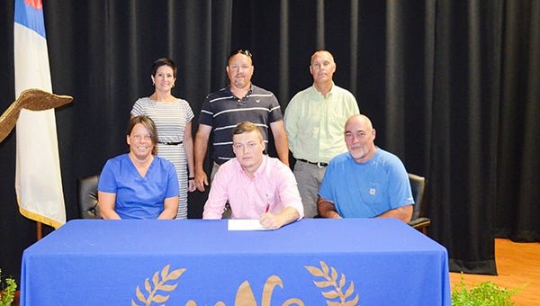 Corey Williams | The Brewton Standard Cooper signs with JDCC. Present at the signing were: back, from left-to-right, WSN principal Patricia Frazier, baseball head coach and assistant principal Coy Campbell, athletic director Doug Hoehn; bottom, left-to-right, mother Sherri Cooper and father Jeff Cooper.
