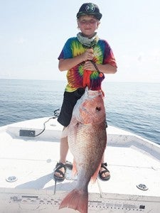 Courtesy photo Brody Hayes holds his 21.5-pound Red Snapper after he catches it.