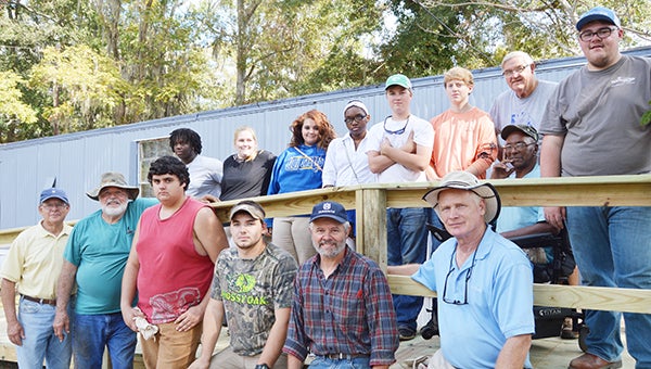 Corey Williams | The Brewton Standard The Methodist Men Ministry and students and faculty of the Escambia County Career Readiness Center pose with residence owner Andrew Jackson after the finishing touches of the ramp.