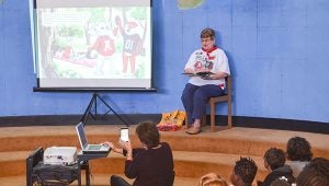 Corey Williams | The Brewton Standard Mancil reads from her book to fourth grade students of BES. Her daughter, Angie Terry, was in attendance to work the projector.