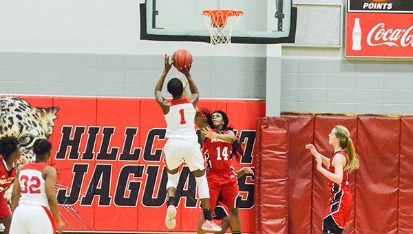Corey Williams | The Brewton Standard Hillcrest's Tyesha Rudolph scores a jump shot as Miller's Raivon Ewing defends. Rudolph finished the game with 32 points.